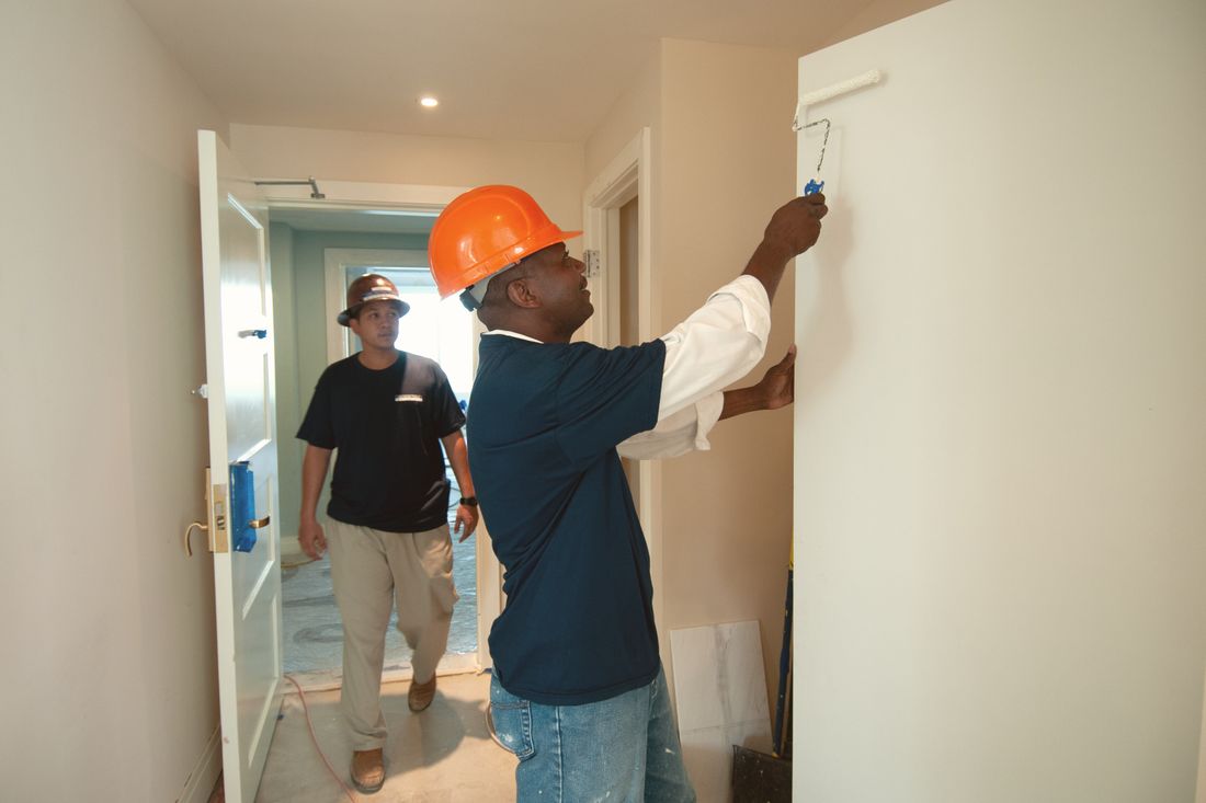 Painters at work on an interior wall